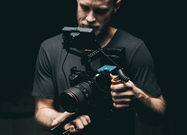 A man holding a professional video camera